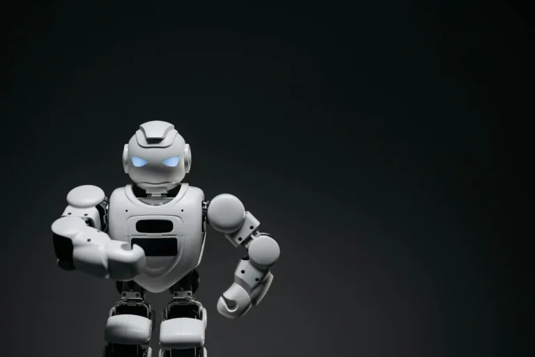 A sleek white robot showcasing modern robotics technology against a dark backdrop.